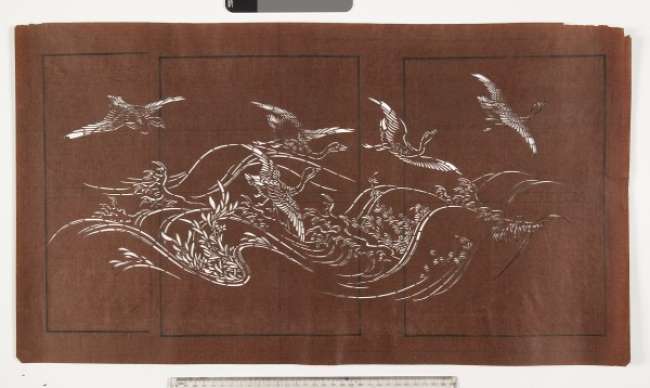 Katagami stencil depicting geese or ducks flying over a rough sea.  Marine flowering  plants are visible amongst the waves.