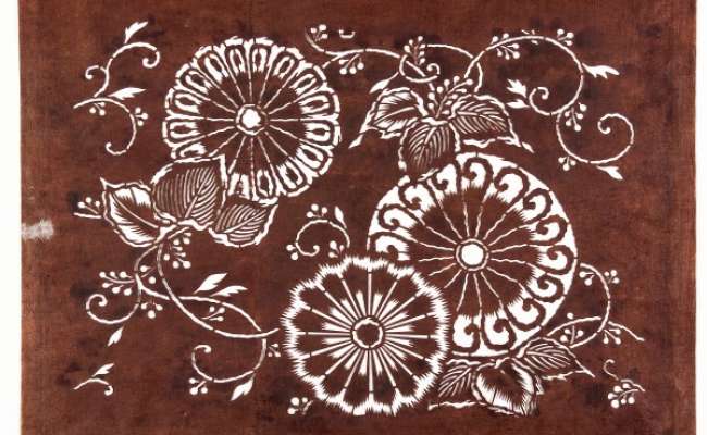 Katagami stencil with a design of karahana  (conventionalised ‘Chinese flowers’)  surrounded by scrolling stems and sprays of paulownia