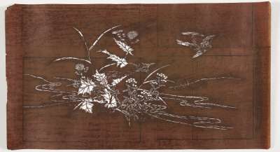 Katagami stencil depicting plants including bamboo and a flying bird on the shoreline