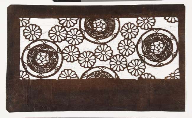 Katagami stencil with a design of chrysanthemums, and roundels with a plum flower in the centre, bordered by bell flowers and scrolling stems