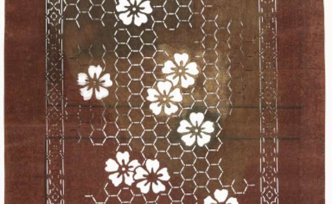 Export Katagami stencil with a design of cherry blossom scattered over a ground pattern of  kikko  (linked hexagons)