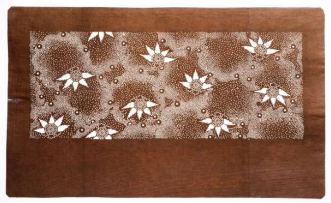 Katagami stencil depicting chrysanthemums against a background of snowflakes.  This  design suggest a late-Autumn to early-Winter season