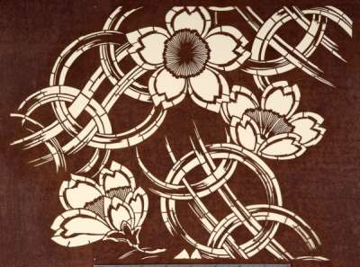 Katagami stencil depicting cherry blossom against a background of interlinked rings and lines
