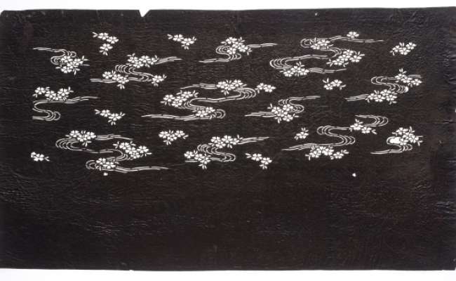Katagami stencil depicting cherry blossom floating on water, imagery associated with late- Spring