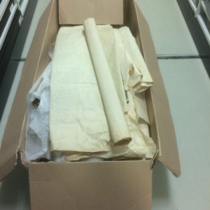 stencilled papers stored rolled in an oversized non-archival cardboard box