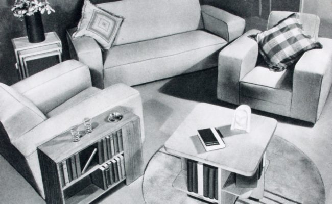 Black and white image of modernist furniture in domestic setting.